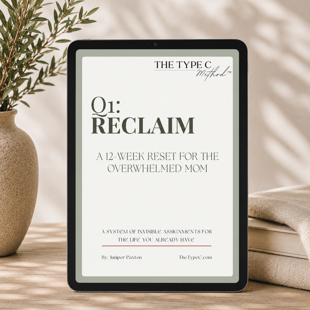 A digital tablet displaying the cover of The Type C Method Q1: Reclaim workbook. The screen shows the title "A 12-Week Reset for the Overwhelmed Mom" framed by a solid sage green border, styled in a minimalist, quiet luxury setting on a wooden table with a textured ceramic vase and soft dappled shadows.